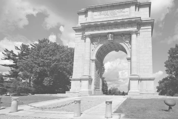 Black-and-white photograph of a stone memorial arch.
